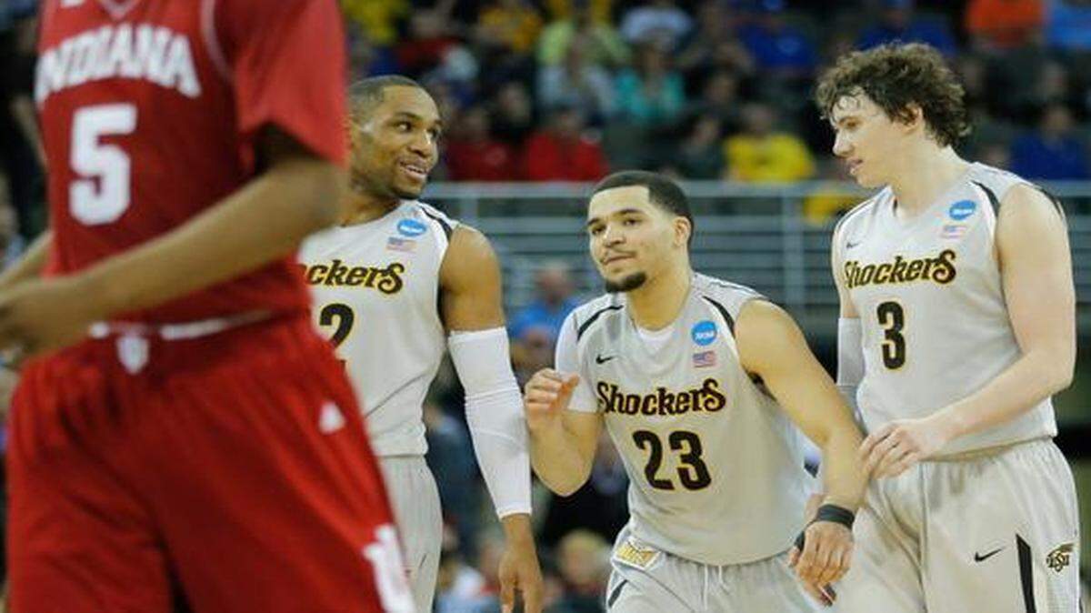 
Wichita State's Fred VanVleet walks down the court with teammates Tekele Cotton and Evan Wessel after the Shockers clinched a win against Indiana on Friday in Omaha.
