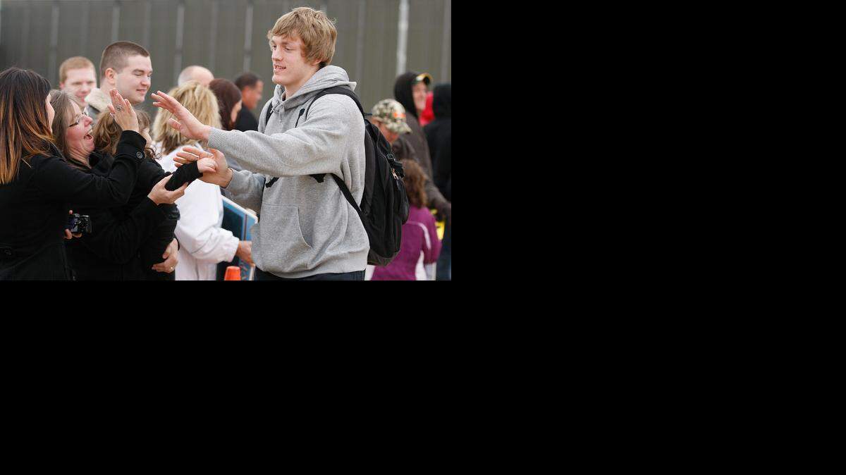 
WSU’s Ron Baker high-fives fans on the way to the Shockers’ charter to the 2013 Final Four.
