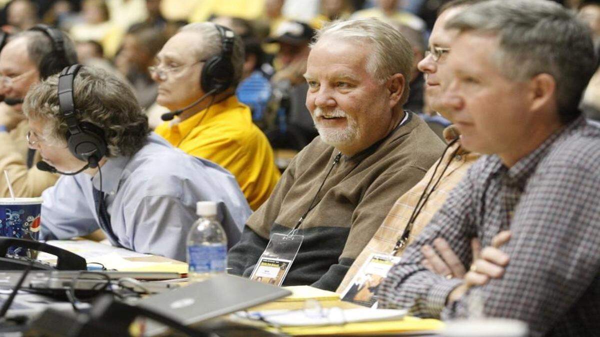 Bob Lutz, center, watches a Wichita State basketball game from press row at Koch Arena.
