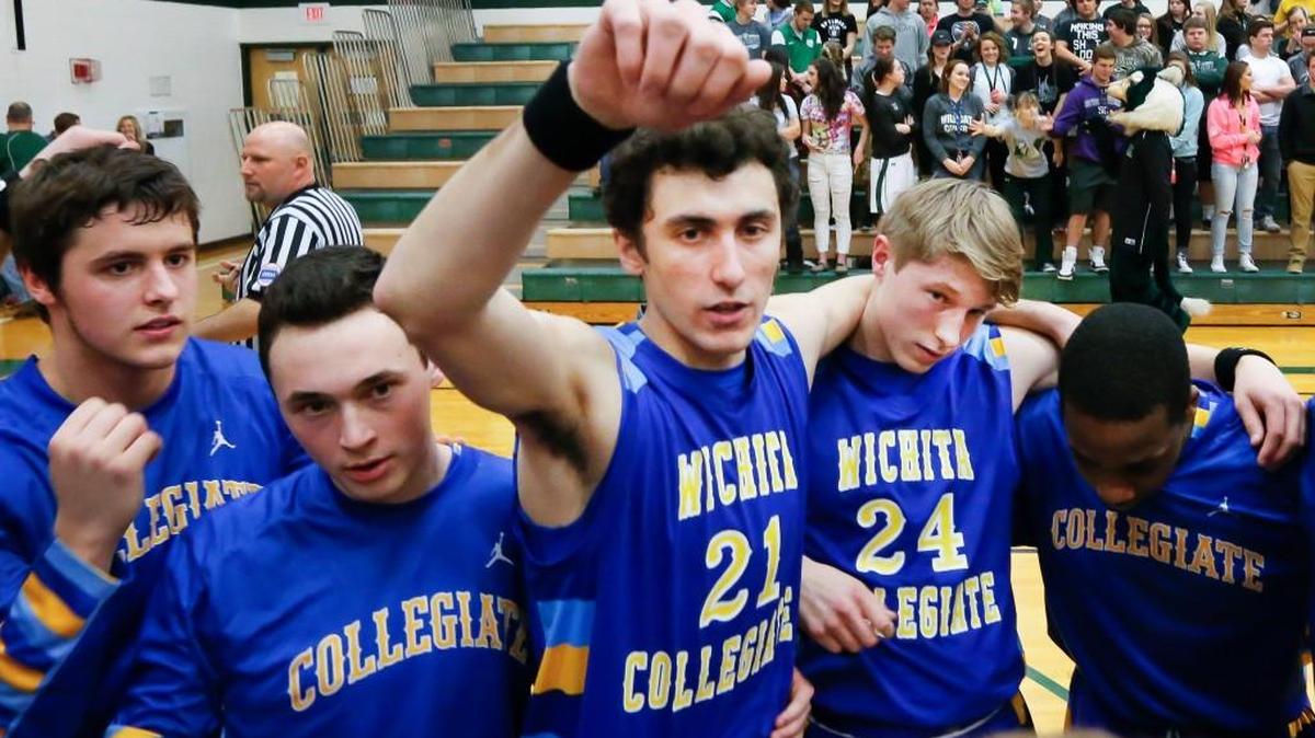 Collegiate’s Cameron Christian (21), Cody McNerney (24) and the rest of the Collegiate squad gather before Friday’s game at Mulvane. Christian’s father, Chris, died Thursday night.