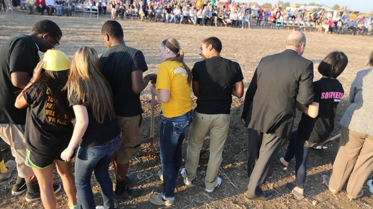 
Southeast High students tossed dirt during the groundbreaking ceremony for the new Southeast High near Pawnee and 127th St. East a year ago. The school will not have a football stadium when it opens in August 2016.
