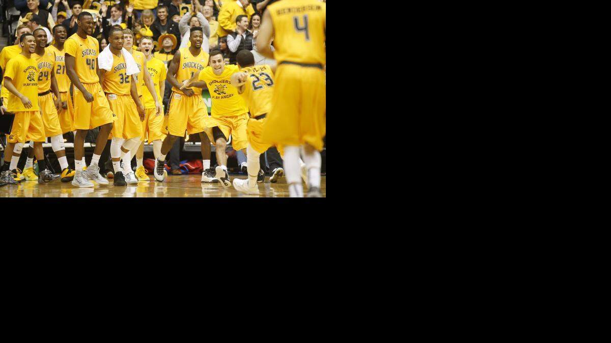 
The Wichita State bench runs out to cheer for Fred VanVleet after he scored a basket in the final seconds of the first half against Evansville on Sunday.
