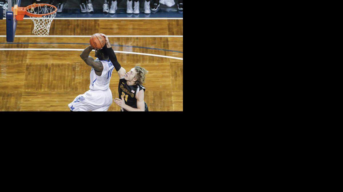 
Wichita State's Ron Baker hustles downcourt to block the shot of Memphis' Chris Hawkins during the first half Tuesday in Sioux Falls, S.D.
