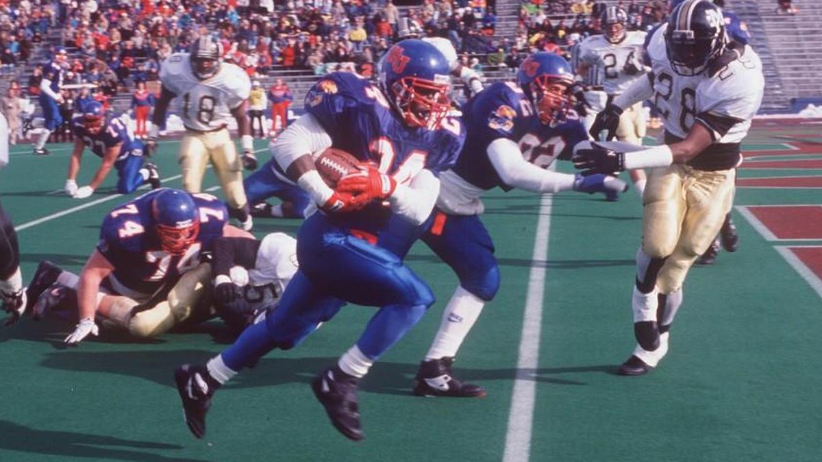 Tony Sands, foreground, runs for a Kansas Jayhawks touchdown against the Missouri Tigers during a record-setting performance in 1991. The 396 rushing yards Sands gained that day remains a single-game record at KU.