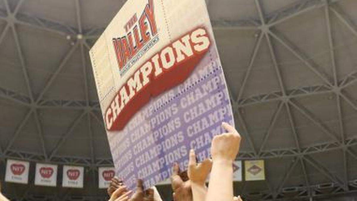 
Guard Jamillah Bonner (5) and her WSU teammates hold a Missouri Valley Conference Champions sign after beating Northern Iowa on Sunday at Koch Arena.
