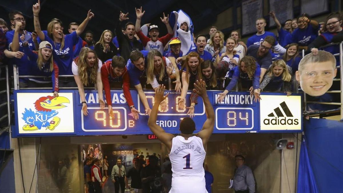 Kansas guard Wayne Selden Jr. high-fives fans as leaves the court after scoring 34 points in an overtime win against Kentucky on Saturday evening at Allen Fieldhouse.
