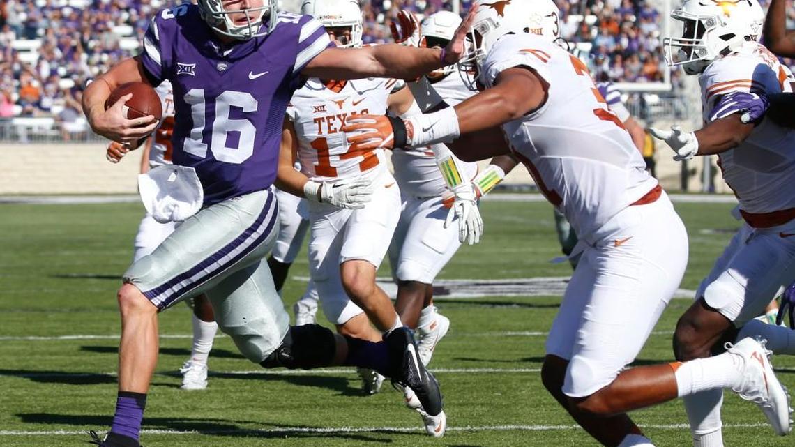 K-State quarterback Jesse Ertz (16) pushes aside Texas safety Jason Hall (31) as he runs for his second touchdown against the Longhorns on Oct. 22.
