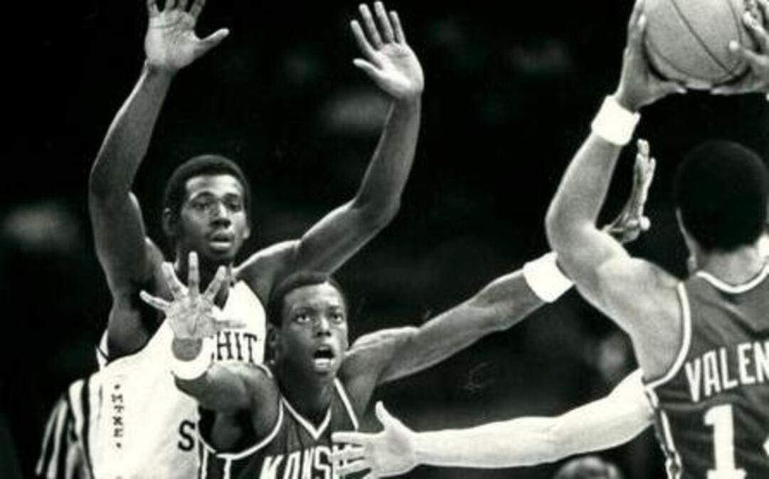 
Wichita State’s Antoine Carr, left, guards Kansas’ John Crawford as Darnell Valentine looks to make an entry pass during the 1981 Midwest Regional semifinal in New Orleans. Valentine had 21 points for KU and Carr had 16 for WSU in the Shockers’ 66-65 victory.
