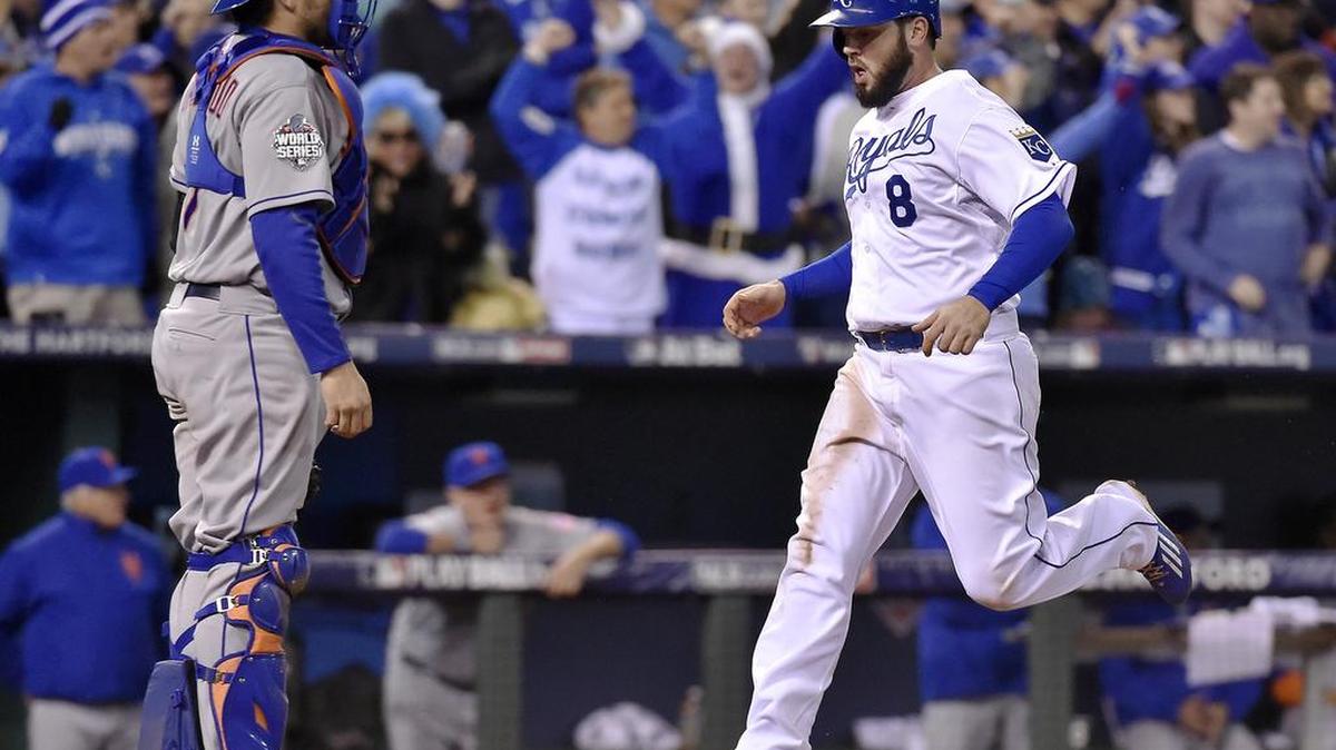 The Royals' Mike Moustakas (8) scores a run past Mets catcher Travis d'Arnaud in the eighth inning on a double by Alex Gordon.