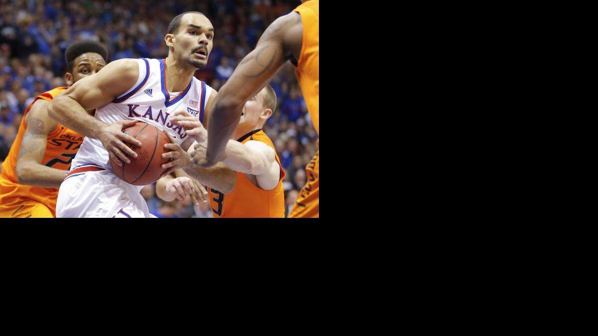 
Kansas forward Perry Ellis tries to find his way to the basket while Oklahoma State guard Phil Forte reaches in during the first half on Tuesday night at Allen Fieldhouse.
