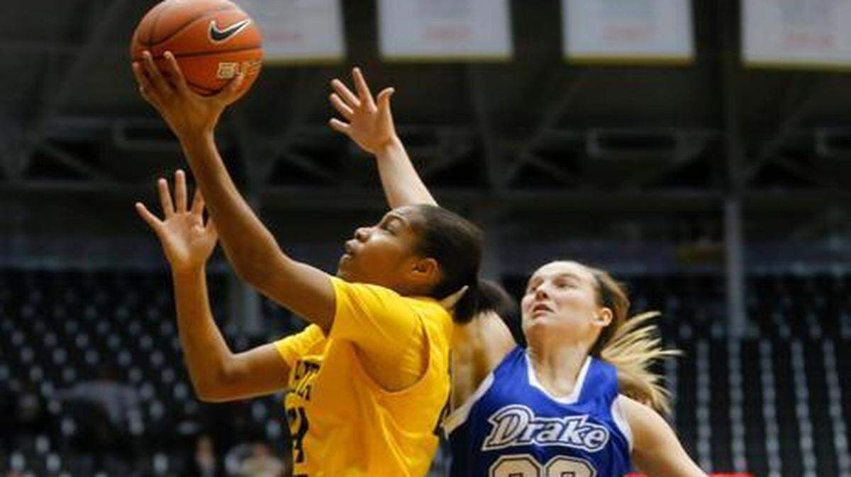 
Wichita State’s Alex Harden goes to the basket against Drake's Caitlin Ingle during a game in February. Harden, WSU’s career scoring leader, will play in her third consecutive NCAA Tournament on Friday.
