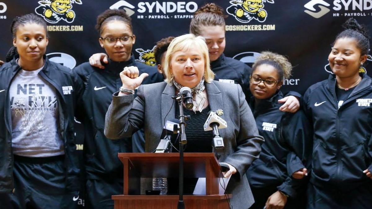 New Wichita State women's basketball coach Keitha Adams, center, talks about her team Monday at Koch Arena.