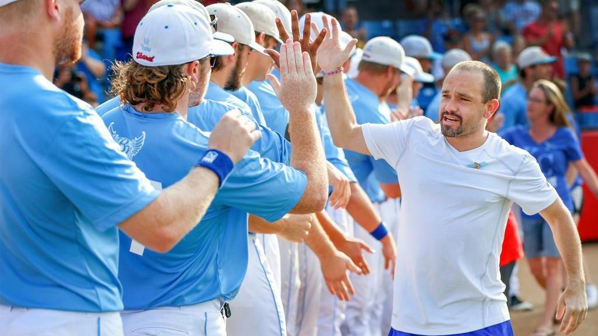 
Chad Carlile, father of Kaiser Carlile, the 9-year-old who died from injuries suffered when he was hit in the head by an on-deck swing, high-fives the Liberal Bee Jays before their game with Seattle during the NBC Tournament at Lawrence-Dumont Stadium on Tuesday.
