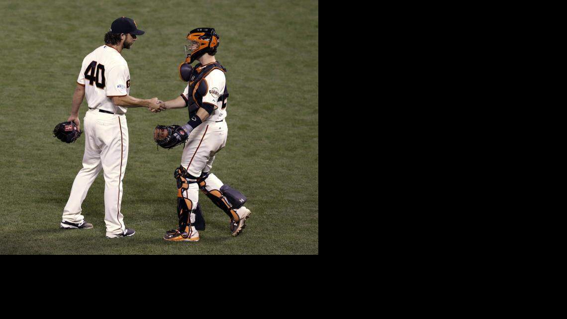 
Giants catcher Buster Posey shakes hands with pitcher Madison Bumgarner after defeating the Royals 5-0 in Game 5 on Sunday night.
