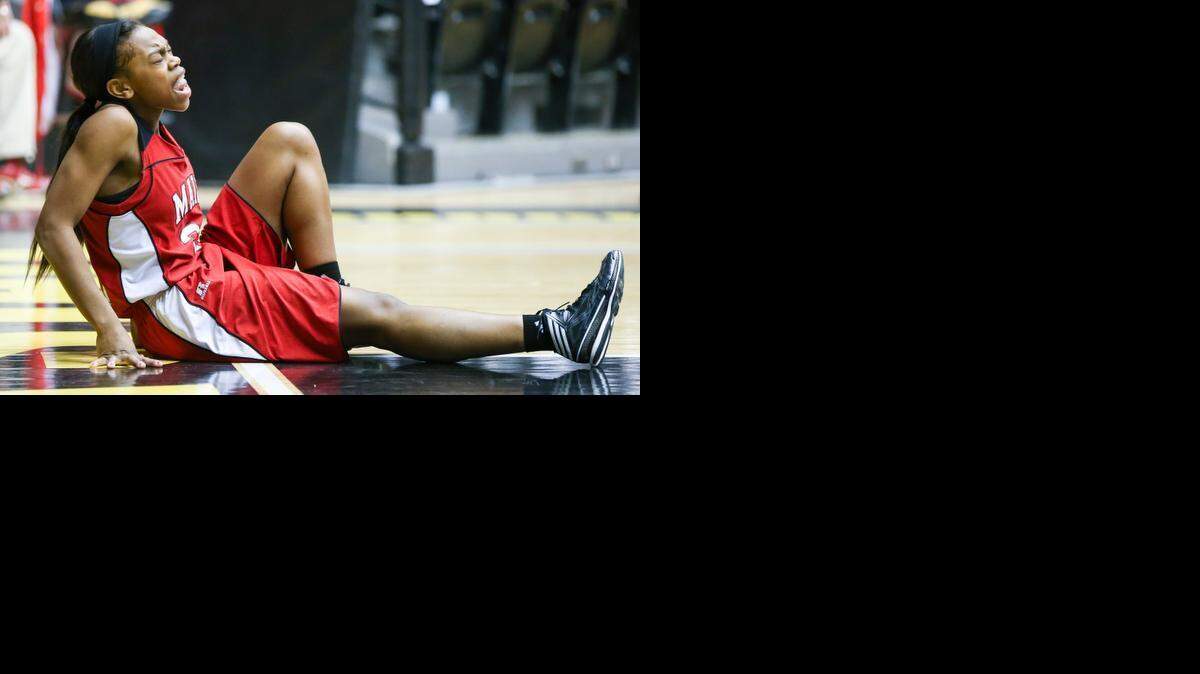 
Maize’s Brianna Johnson grimaces after hurting her knee against Manahattan in the 2014 Class 6A tournament. She had surgery to repair an ACL tear, came back this season, then injured her other knee during last week’s sub-state.
