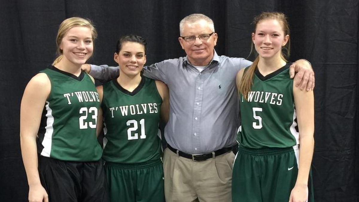 South Central girls basketball coach Tim Rietzke with three of his players: Micaela Jellison (23), Reagan Bayne (21) and Haley Unruh (5).
