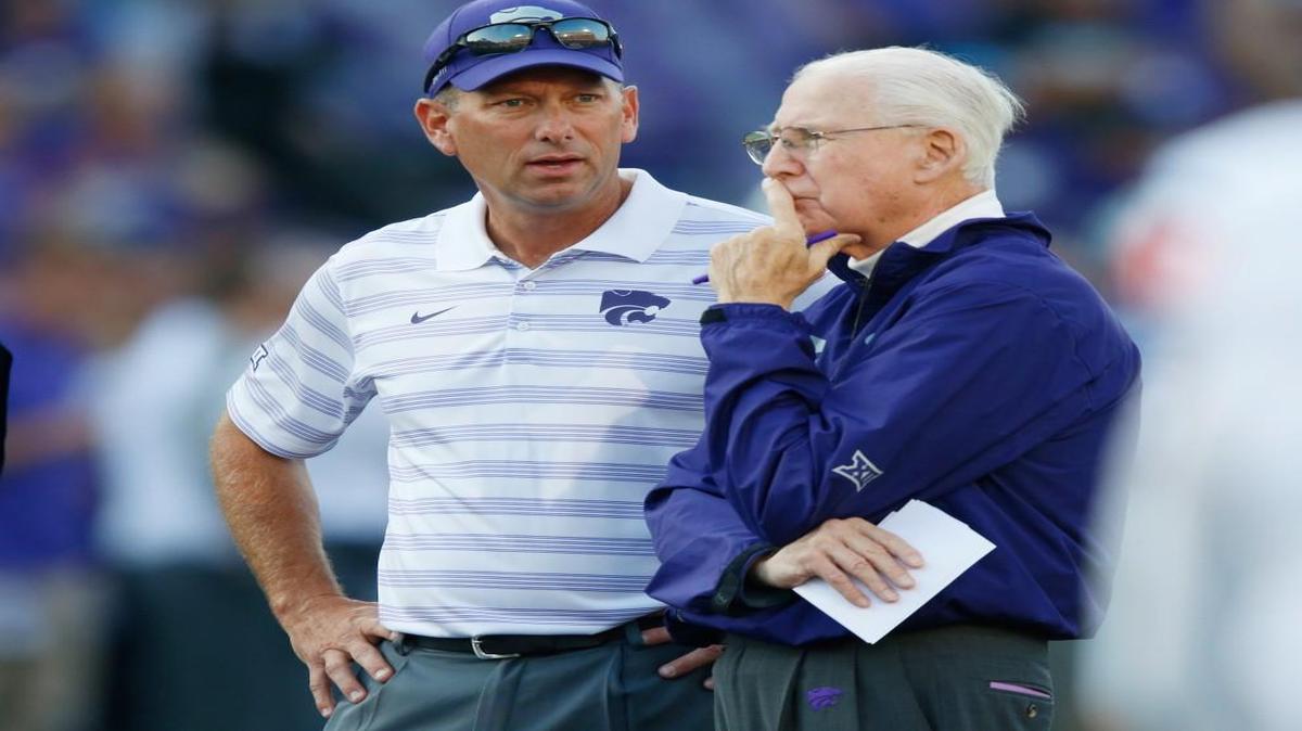Associate head coach Sean Snyder, left, talks last season with his father and K-State coach Bill Snyder. “He still has a wonderful way about connecting and communicating and gaining respect from young people,” Sean said of his father.