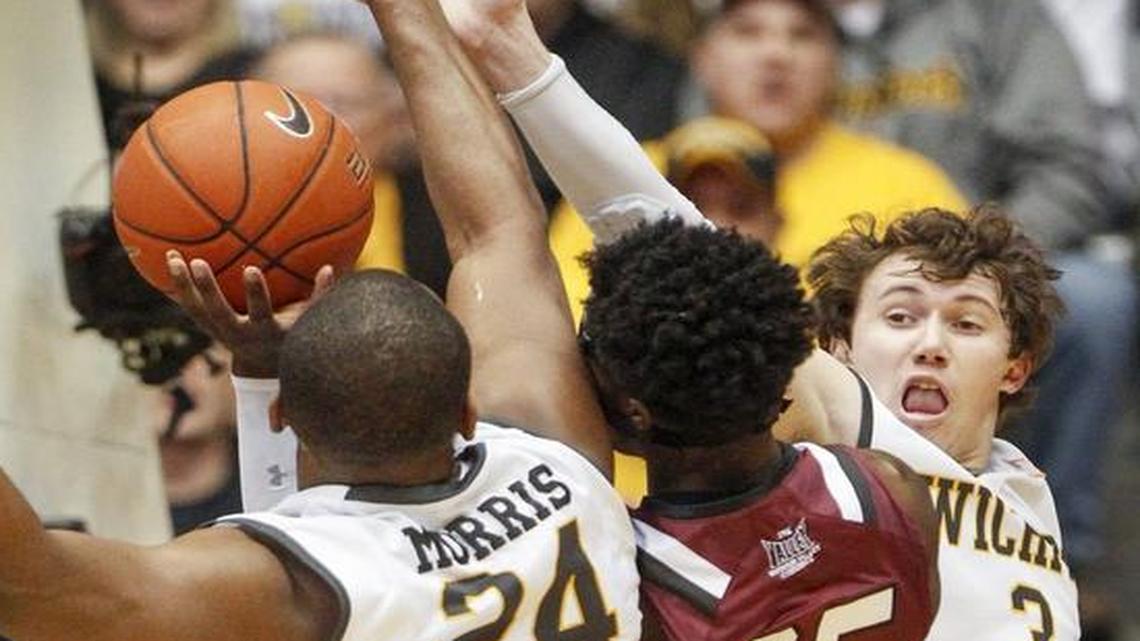 Wichita State’s Evan Wessel (3) and Shaquille Morris play defense against Southern Illinois’ Anthony Beane (25) during the first half Wednesday.
