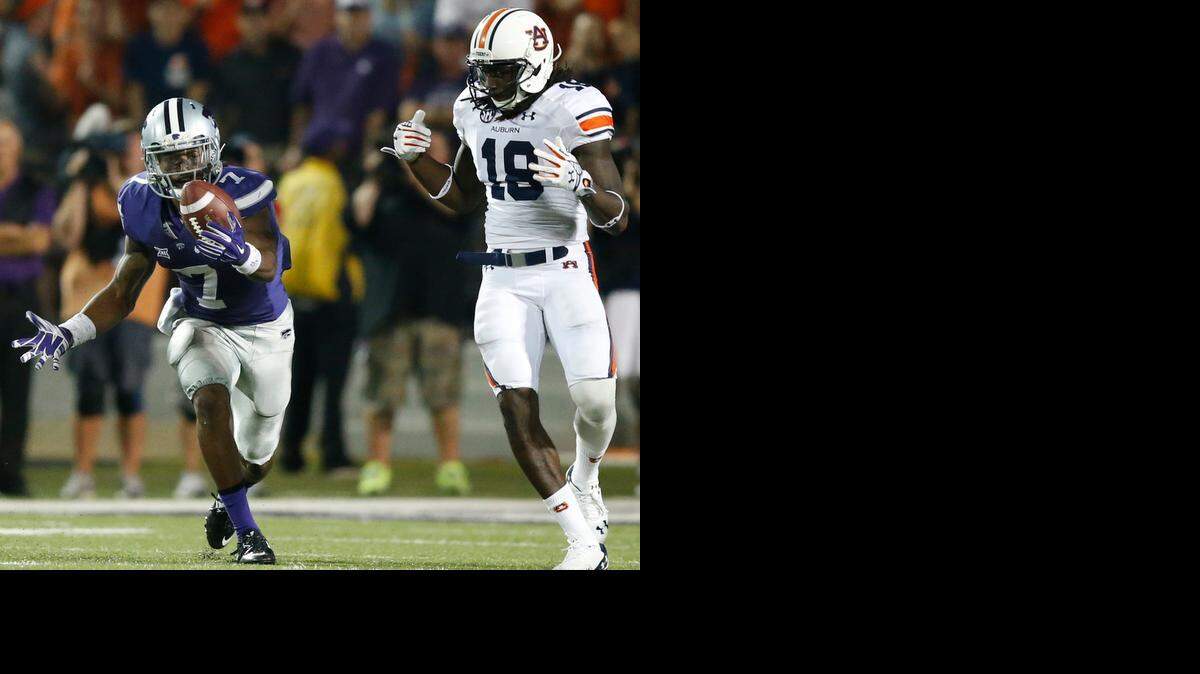 
Kansas State defensive back Danzel McDaniel, left, juggles a pass intended for Auburn wide receiver Sammie Coates in the fourth quarter.
