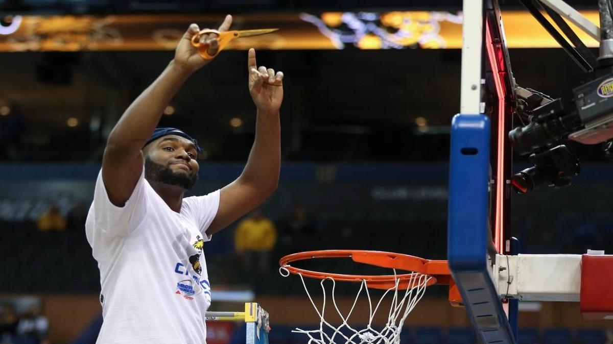 Wichita State center Shaquille Morris cuts a piece of net after the Missouri Valley Conference Tournament championship game in St. Louis last month.