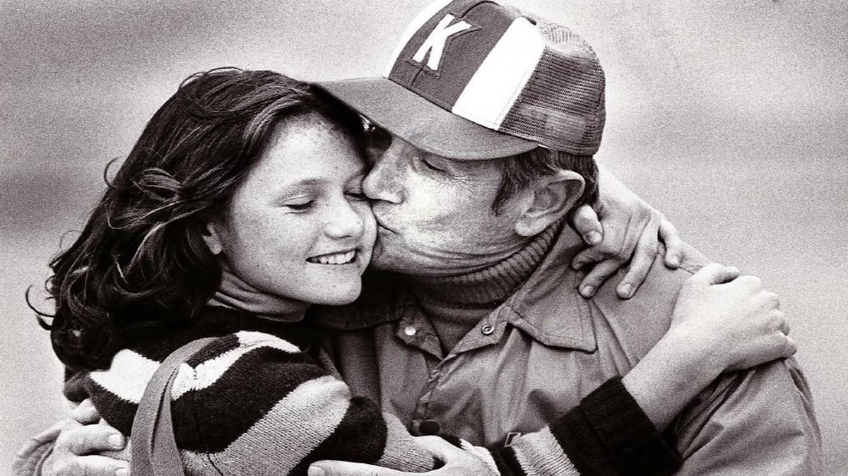 Kapaun coach Ed Kriwiel kisses his daughter, Suzanne, after the Crusaders won the 1981 Class 5A championship.
