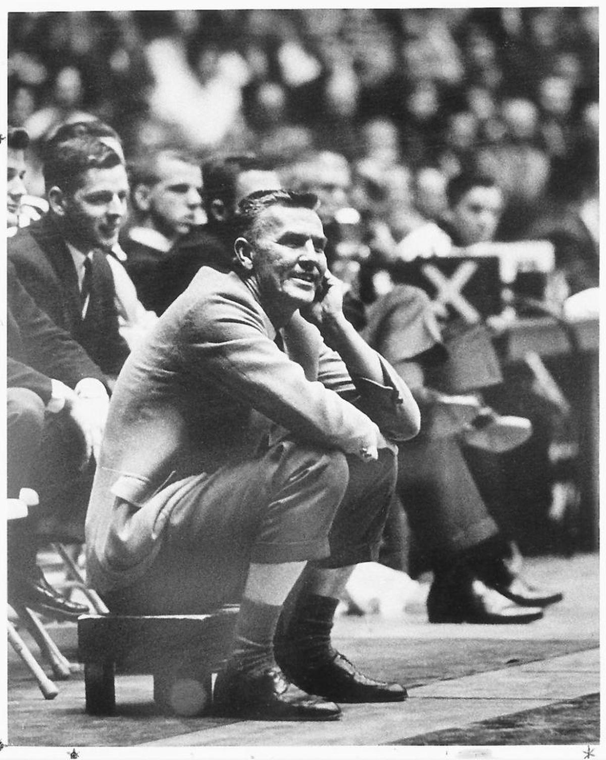 Legendary Univerity of Wichita basketball coach Ralph Miller sits on his stool on the sideline of a game in the early 1960s.