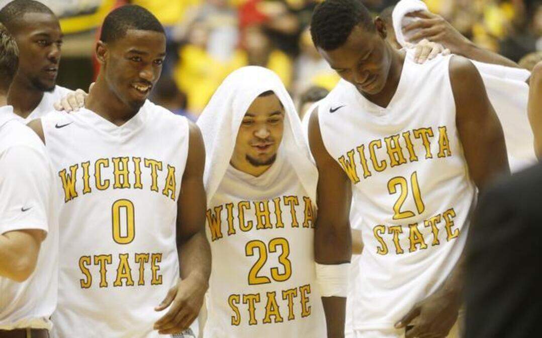 
Wichita State guard Fred VanVleet, center, walks off the court hugging teammates Rashard Kelly, left, and Bush Wamukota after WSU beat Tulsa 75-55 on Saturday at Koch Arena.
