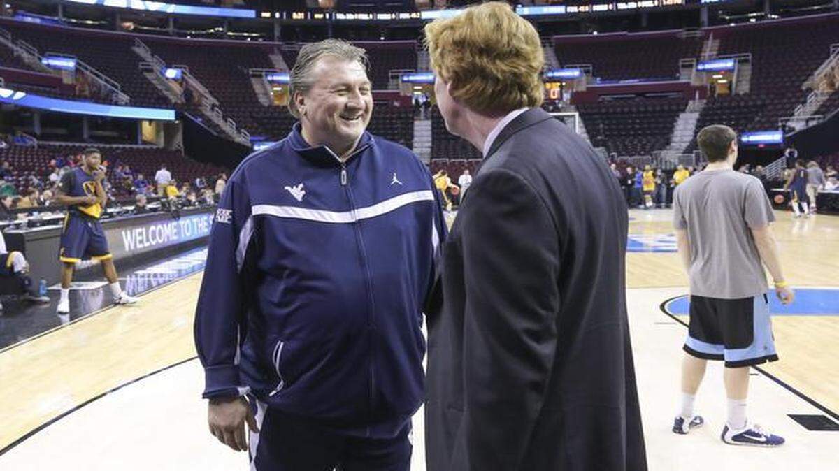 
West Virginia coach Bob Huggins visits with a reporter on the edge of the court during his team's practice Wednesday in Cleveland. 
