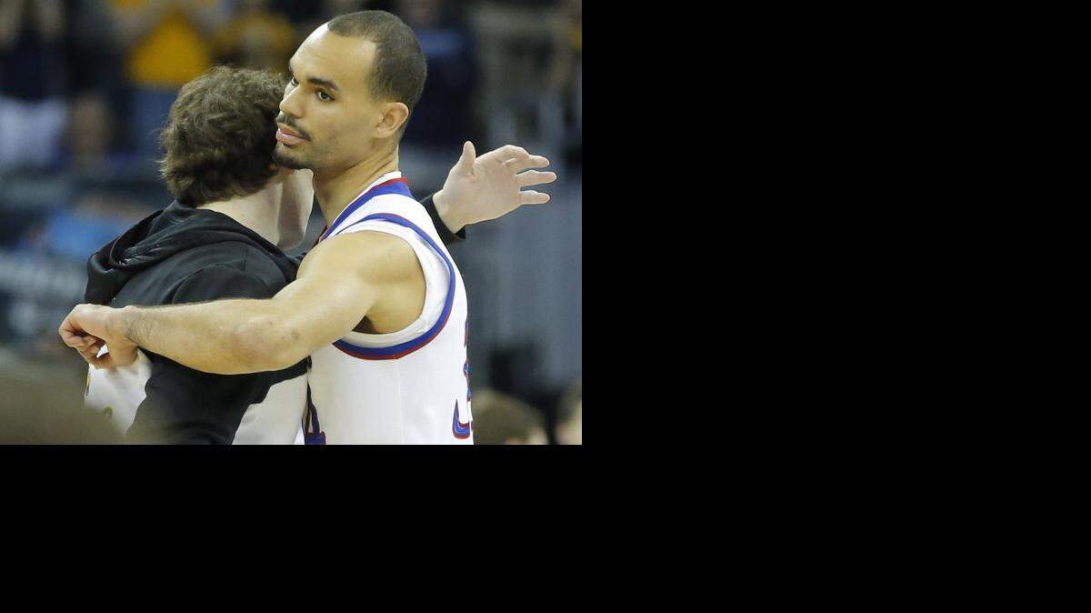 
Kansas' Perry Ellis hugs former high school teammate and current Shocker Evan Wessel during introductions before the Kansas-Wichita State game in the NCAA Tournament last month in Omaha.
