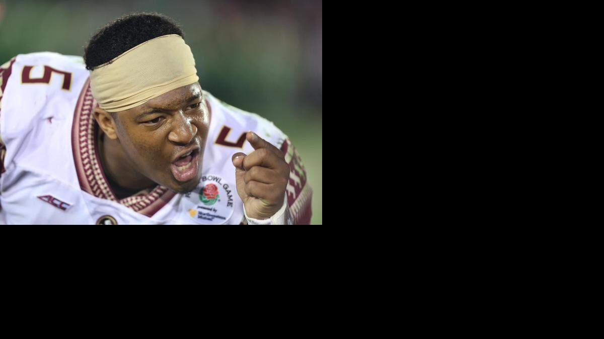 
Dejected FSU quarterback Jameis Winston tries to inspire teammates late in the game against Oregon during the Rose Bowl College Football Semifinal game on Jan. 1.

