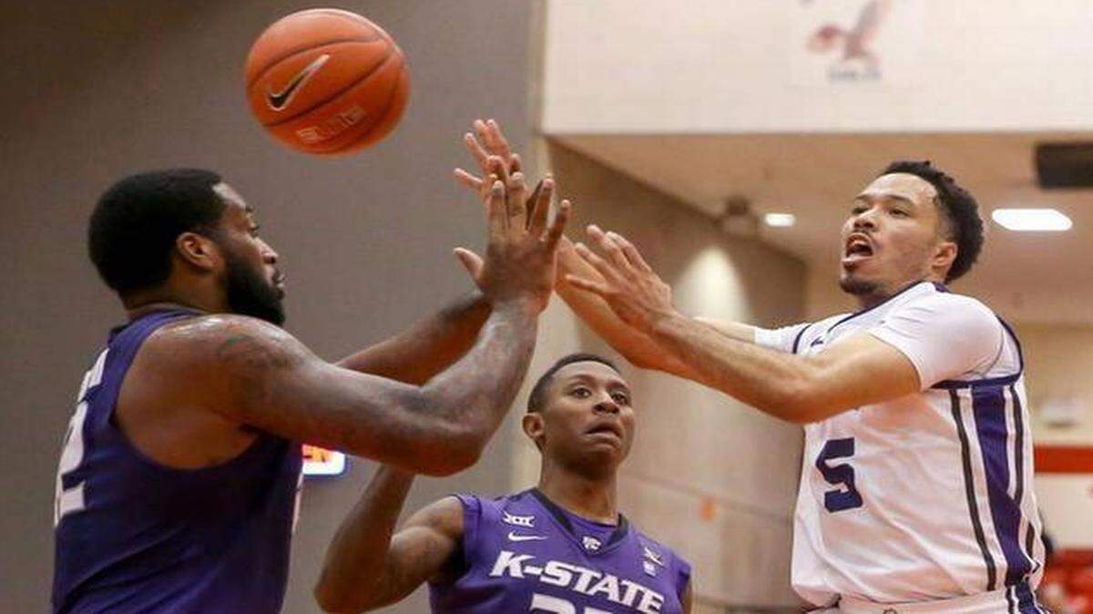 
TCU guard Kyan Anderson (5) tries to make a pass around Kansas State forward Thomas Gipson (42) and guard Nigel Johnson (23) during Wednesday night’s game in Fort Worth.
