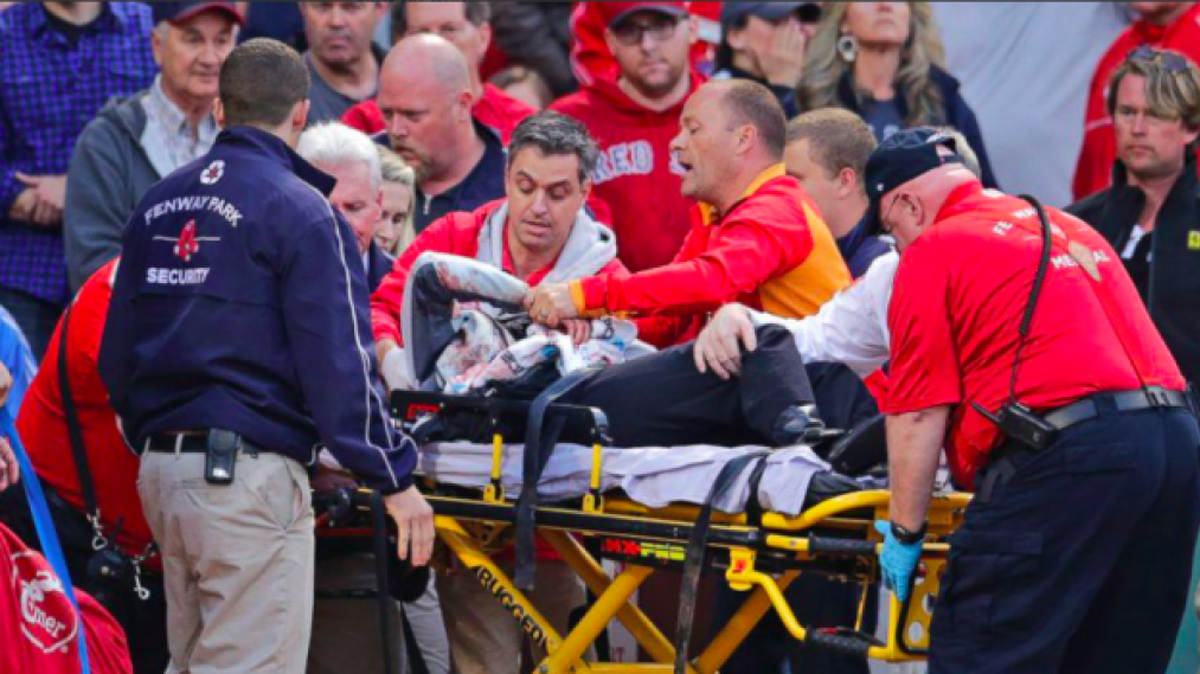 
A fan is attended to after being struck by a broken baseball bat during a game at Fenway Park in June.
