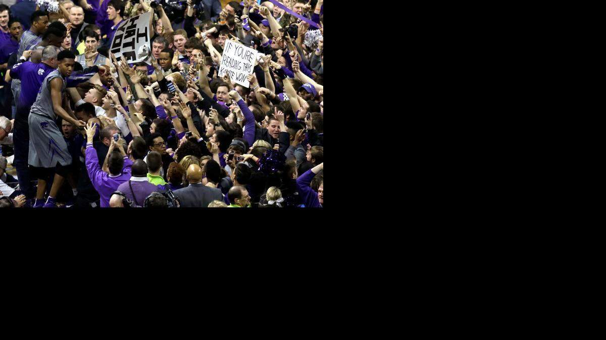 
Kansas State players including Wesley Iwundu, left, shake hands with fans after beating No. 8 Kansas on Monday night.
