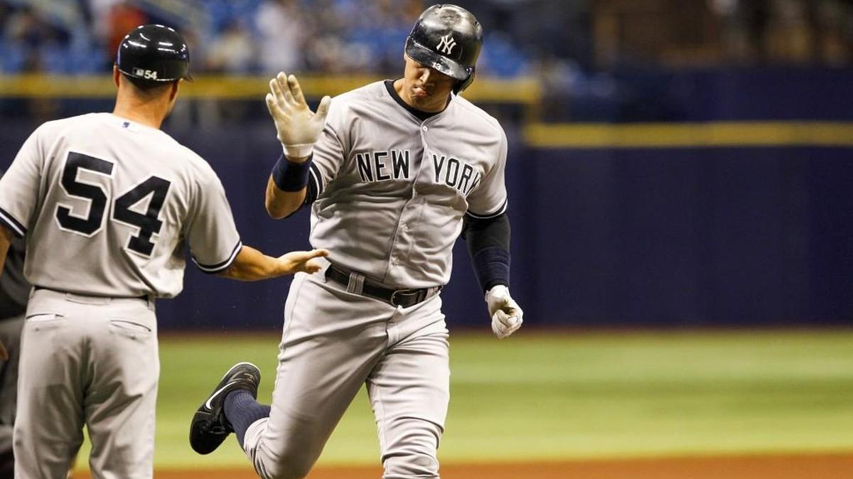 
The New York Yankees' Alex Rodriguez high-fives third base coach Joe Espada after a solo home run in the first inning against the Tampa Bay Rays at Tropicana Field on Tuesday.

