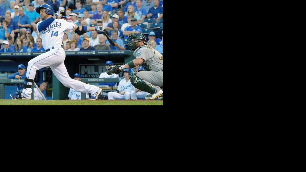 
The Royals' Omar Infante (14) follows through on his two-run home run in the third inning in front of Oakland Athletics catcher Derek Norris on Wednesday, Aug. 13, 2014, at Kauffman Stadium in Kansas City, Mo. The Royals won, 3-0. (John Sleezer/Kansas City Star/MCT)
