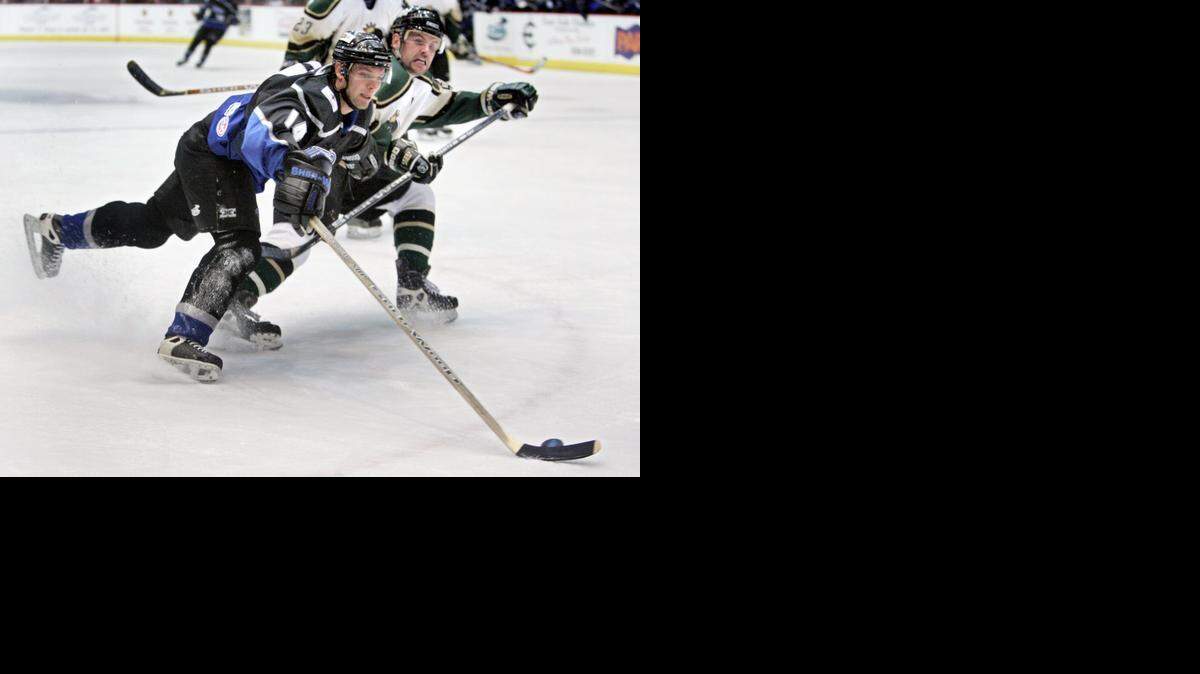 
The Thunder’s Joe Blaznek (left) brings the puck in toward the goal in front of Memphis player Derek Landmesser in a 2004 game at the Kansas Coliseum.
