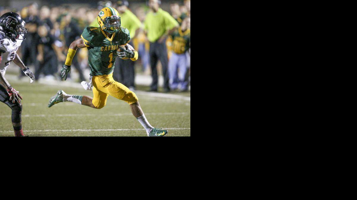 
Bishop Carroll's Denzel Goolsby runs for a TD against Heights during a 2014 regular-season game in September.
