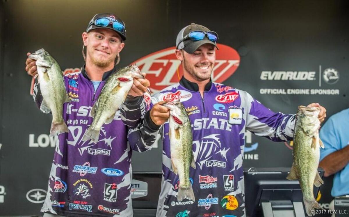 Kyle Alsop, left, and Travis Blenn hold up some of the bass they caught Friday as they won the FLW college fishing national championship at Lake Wheeler in Alabama, beating more than 100 teams from 32 states.