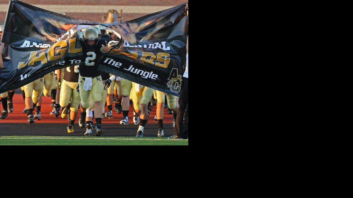 Kevin Olney (2) leads the charge for the Andover Central Jaguars as they play their game against the Maize South Mavericks at Andover District Stadium.