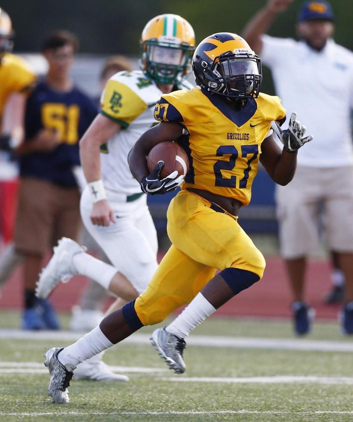 Northwest's Roy Johnson runs in the open field as he returns a Bishop Carroll kickoff for a touchdown in the second quarter Thursday night. Bishop Carroll won 40-35.