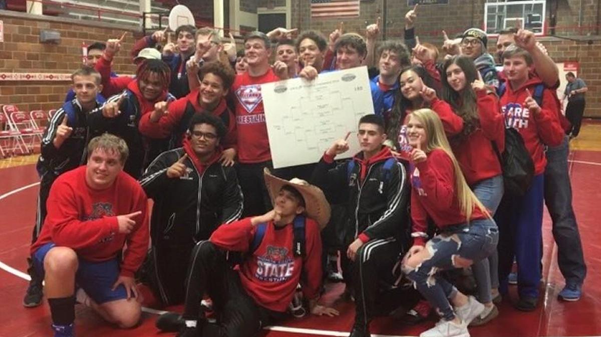 South’s wrestling team celebrates after adding the City League tournament title to its regular-season crown.