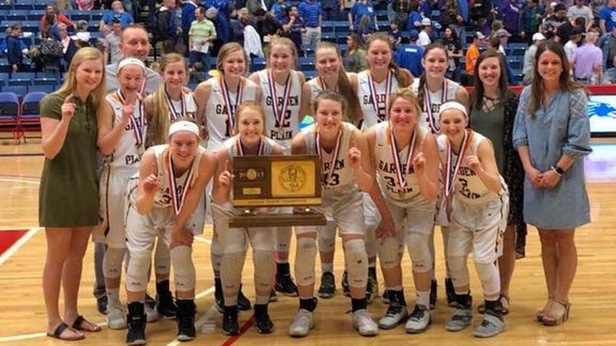 Garden Plain senior Taylor Joplin (front, center) and her team pose with the Class 3A girls basketball trophy. The Owls beat Royal valley 49-39 in the state championship game Saturday, March 10, 2018, at the Hutchinson Sports Arena.