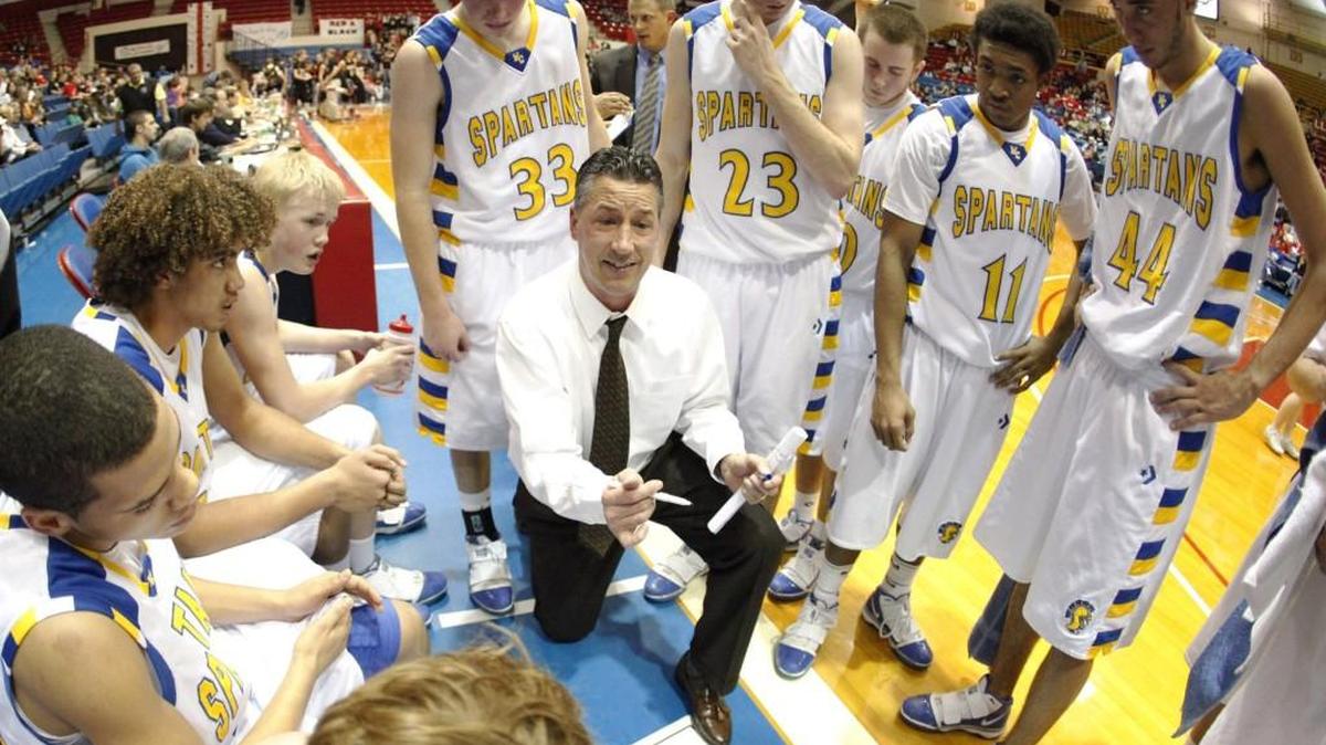 Collegiate head basketball coach Mitch Fiegel talks to his team during a timeout.