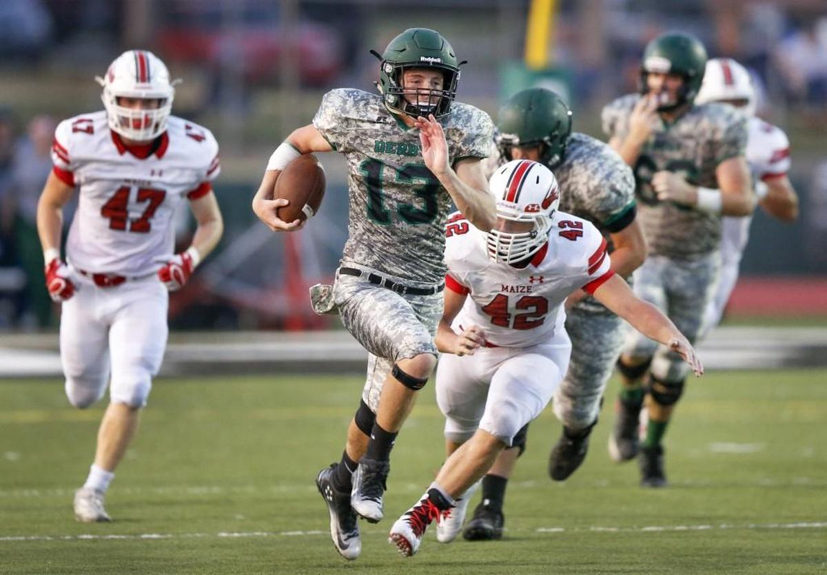 Derby QB Grant Adler (13) heads downfield for a large gain against Maize during the second quarter Friday.