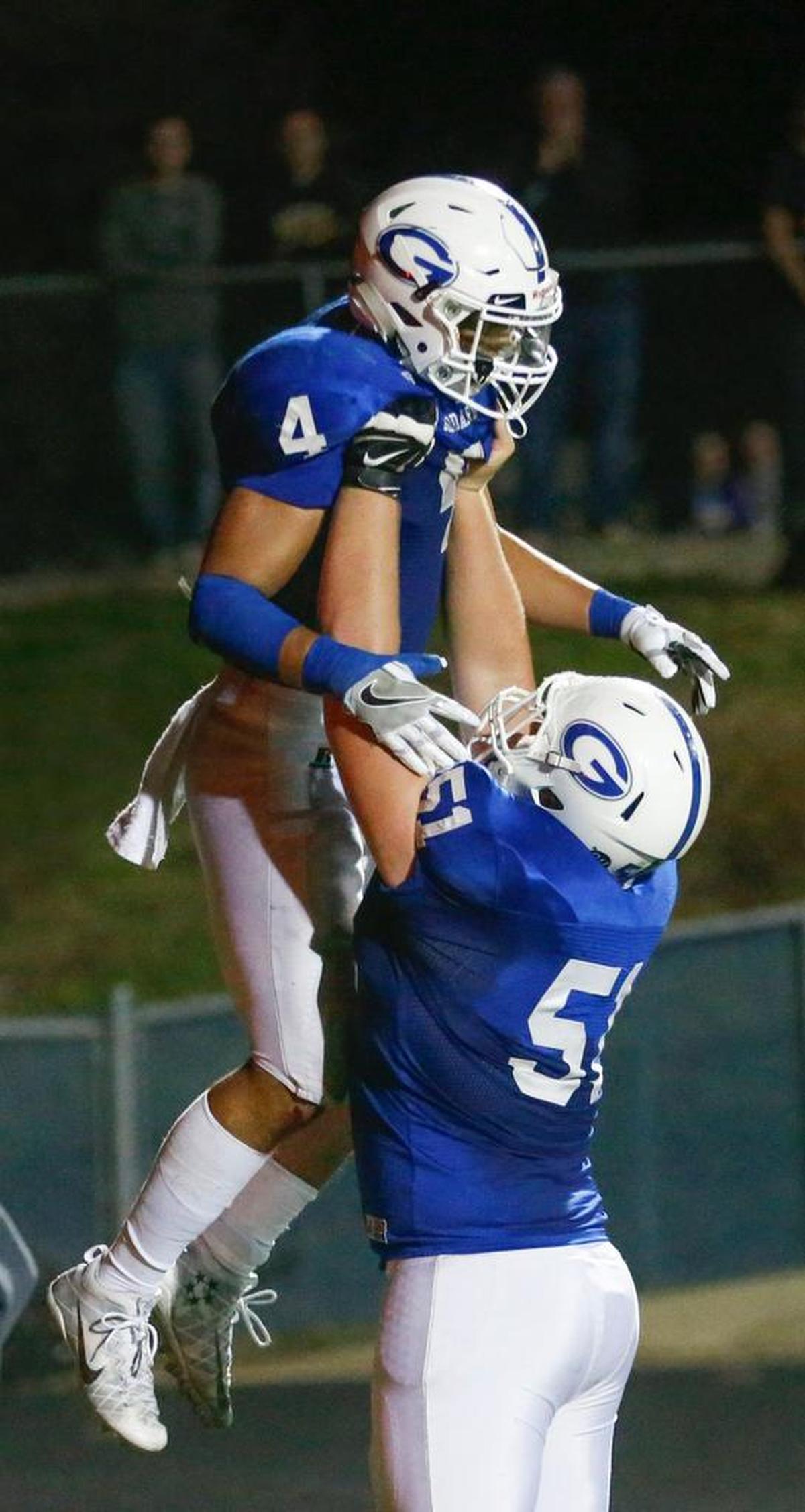 Goddard’s Kody Gonzalez (4) gets congratulated by teammate AJ Vang (51) after sealing the game with his second touchdown against Bishop Carroll in the fourth quarter in their playoff game Friday at Goddard. (Nov. 4, 2016)
