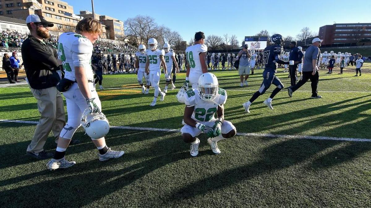 Derby safety Javon Davis sits on the turf as Blue Valley North celebrates their 49-42 win after the Class 6A championship game Saturday in Emporia.