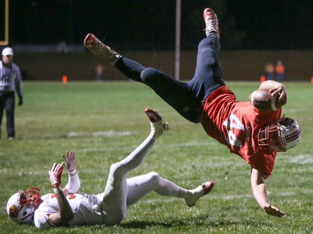 Hesston running back Parker Roth (44) goes airborne against Hoisington.