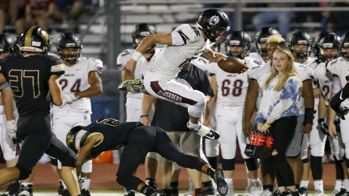 Buhler's Dalton Smyres jumps over a Maize South defenders after a reception in the second quarter Friday at Maize South. Both teams are part of the race for 4A-I West supremacy.