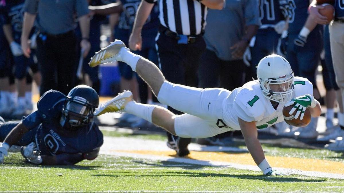 Derby’s Brody Kooser leaps for a first down past Blue Valley North safety DreSchaun McCallop during the Class 6A championship game in November. Kooser was chosen the West team for the Shrine Bowl.