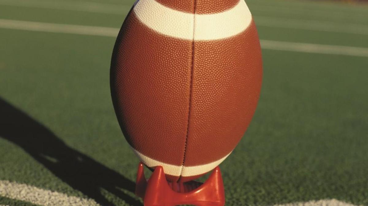 The Manhattan High School football coach was under scrutiny after a “birthday beatdown” hazing incident came to light. He will not face child endangerment charges.